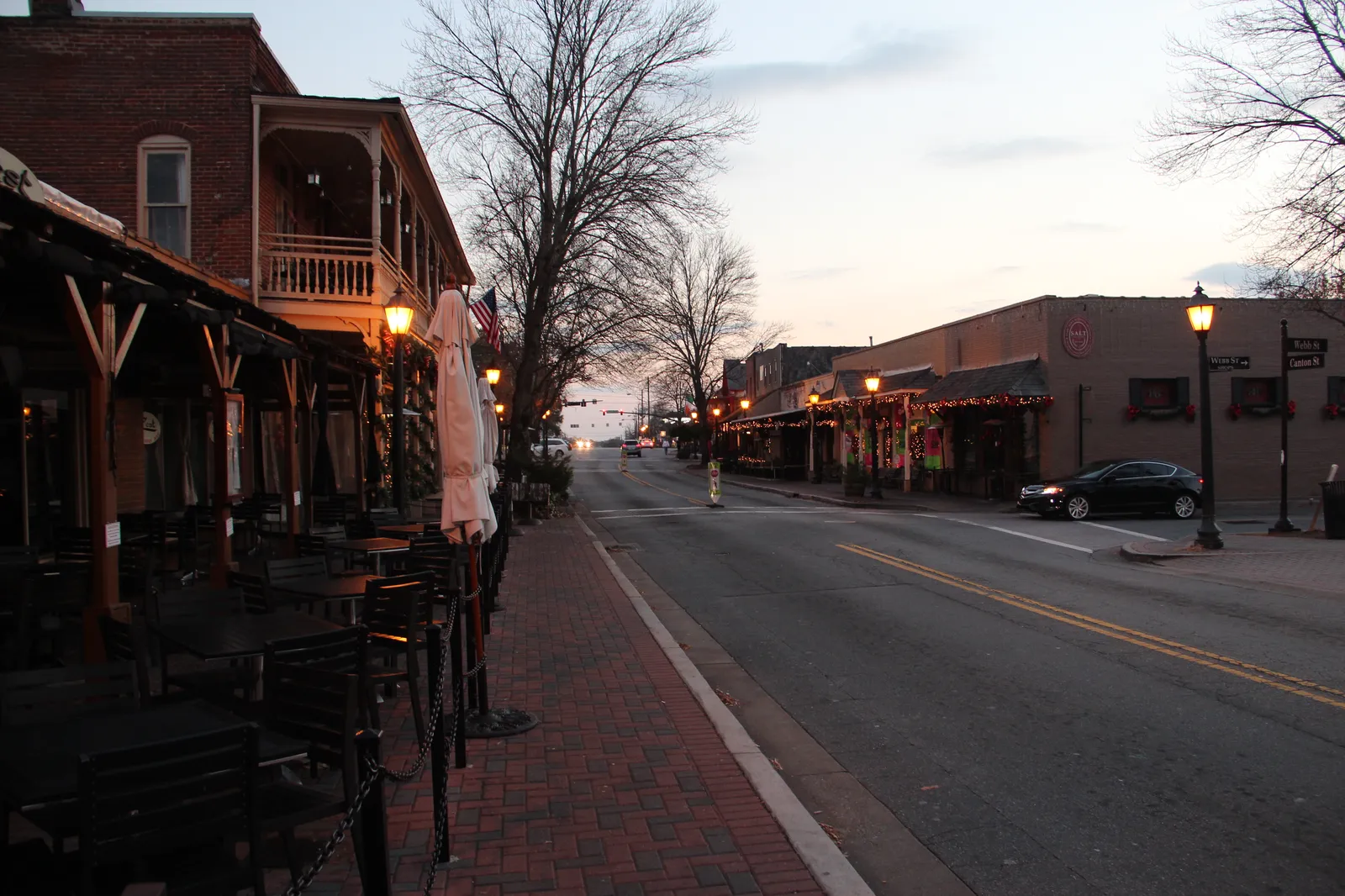 Holiday wreaths and lights on Canton Street in downtown Roswell at dusk