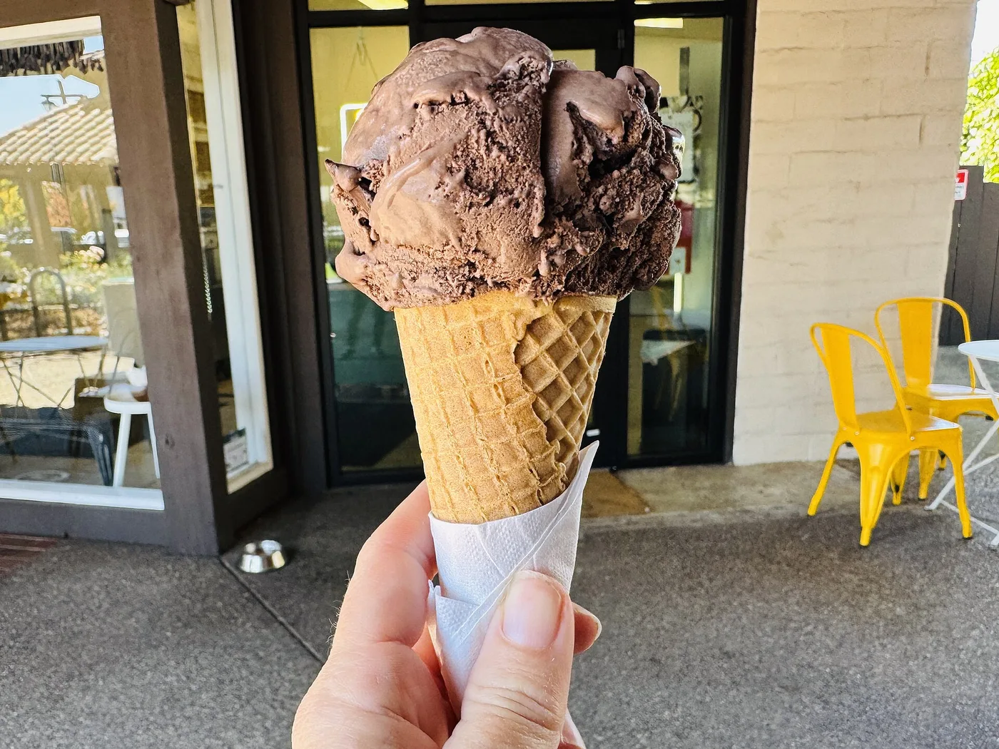 A scoop of chocolate ice cream on a sugar cone. The photo was not taken in Roswell.
