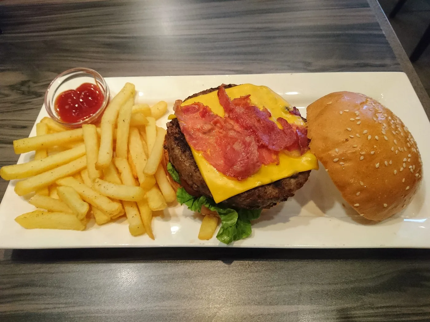 A bacon cheeseburger with french fries. The photo was not taken at a Roswell restaurant.