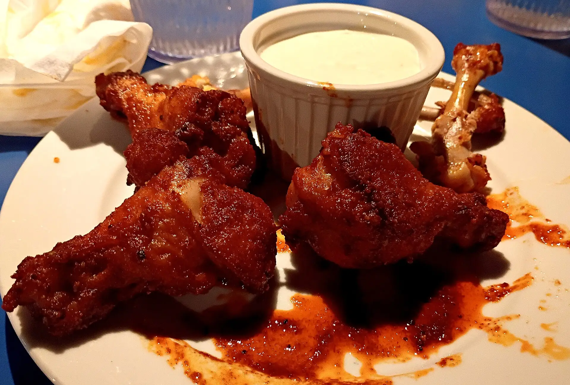 A plate of chicken wings with a cup of ranch. The photo was not taken at a Roswell restaurant.